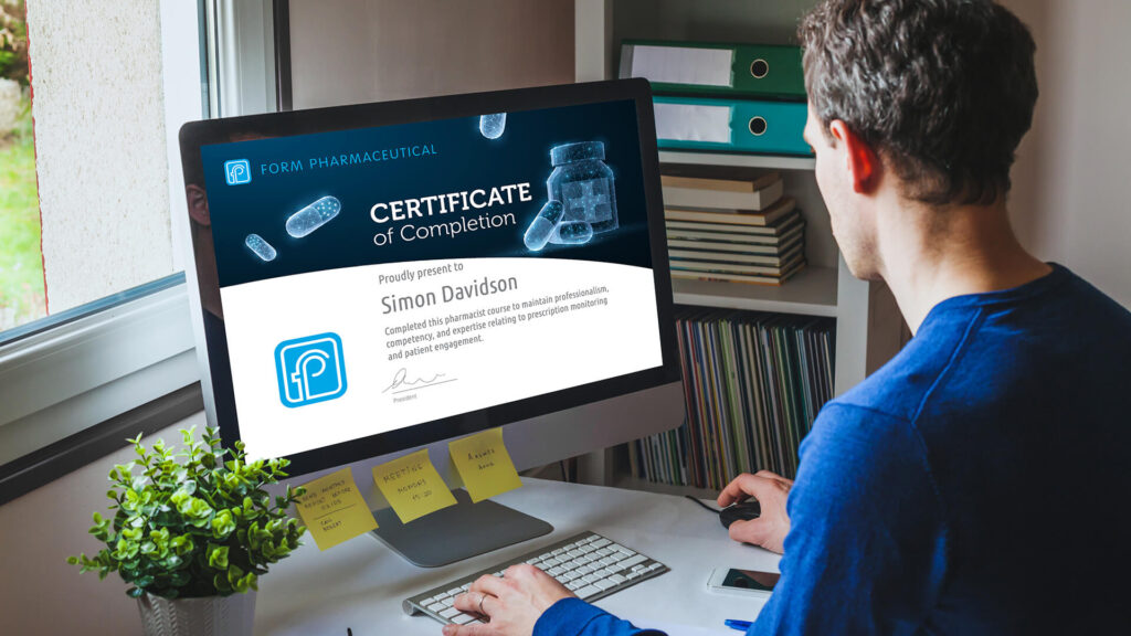 Businessman sitting a desk looking at a certificate of completion