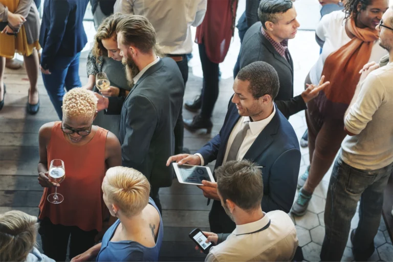 A large room full of people in business attire photographed from a high angle.