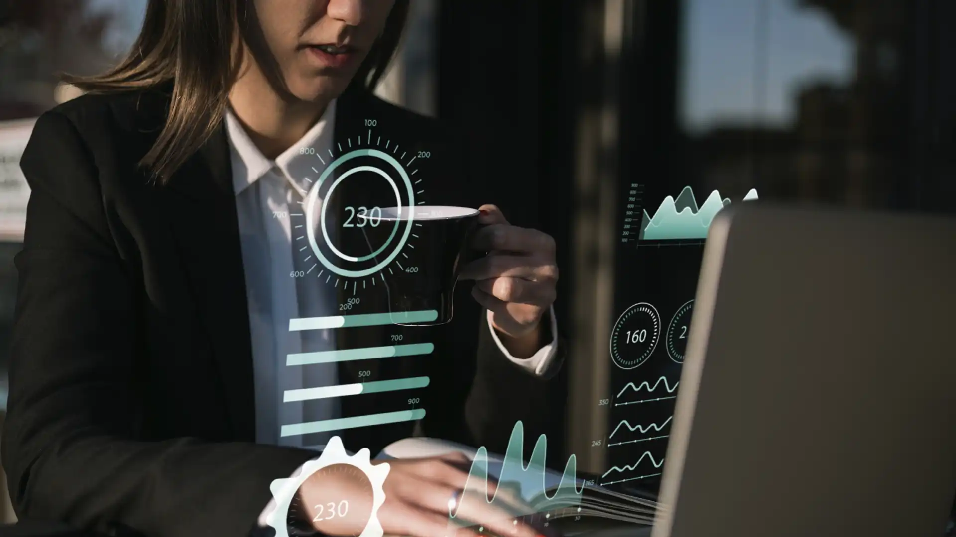 image of a woman sitting in front of a computer as charts hovers above it representing globalmeet's virtual event crm integrations for measuring event success