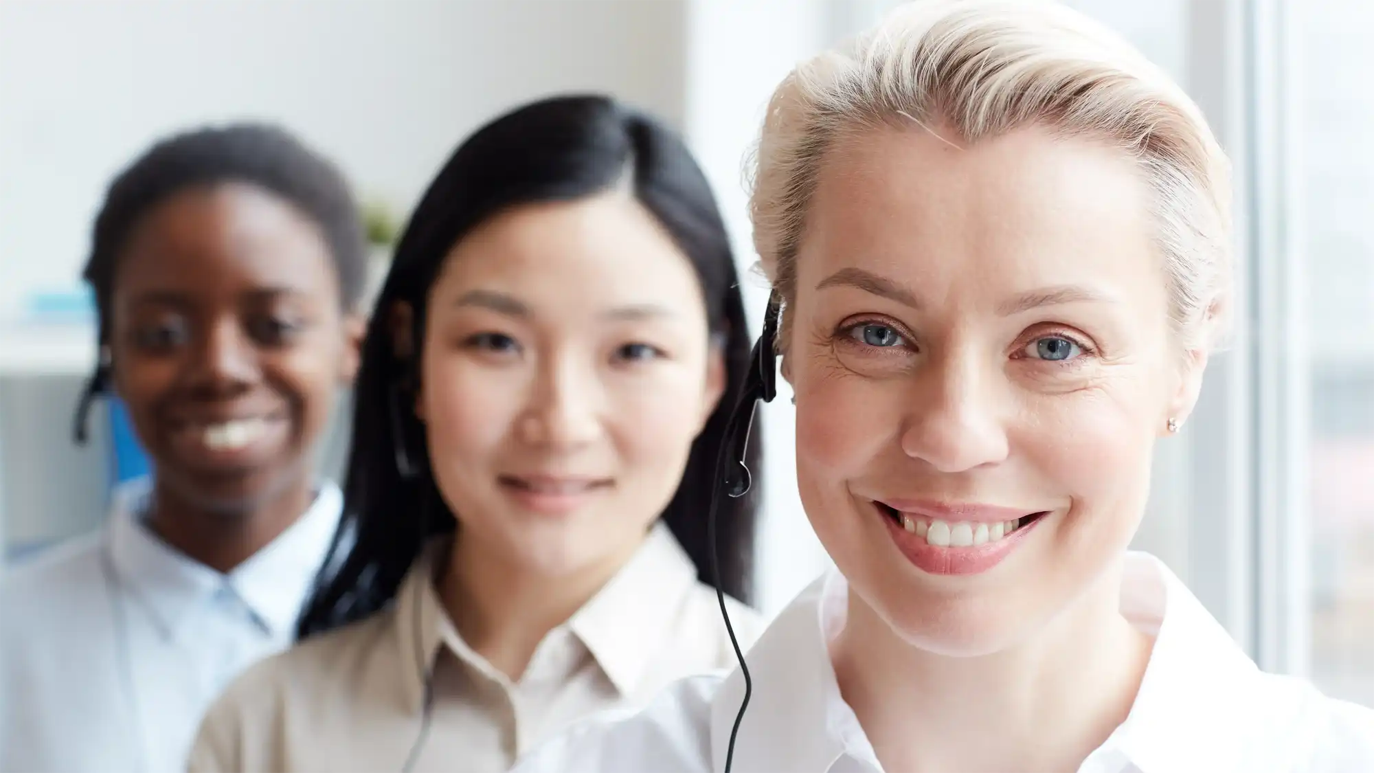 photo of three women in headsets representing globalmeet's conference call operators